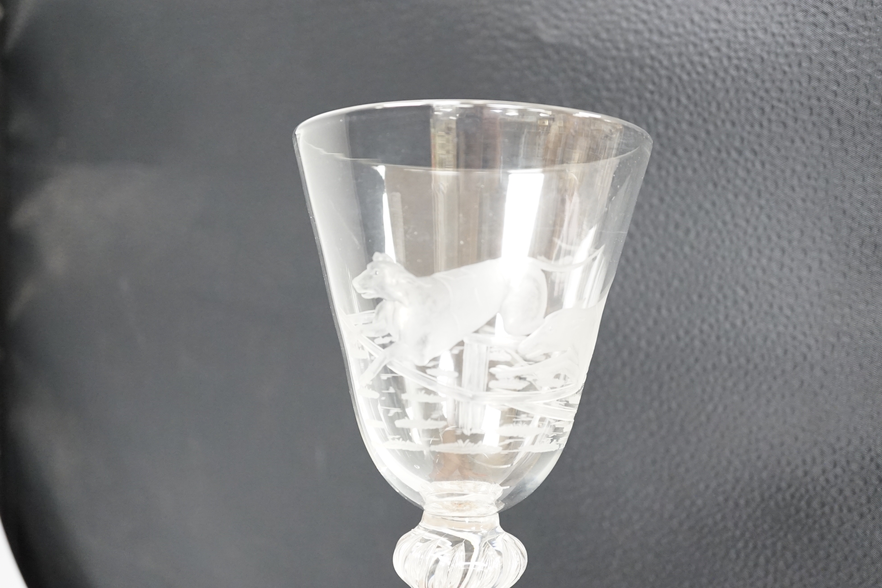 An English lead crystal mammoth trophy goblet, 19th century / early 20th century, engraved with two racing greyhounds, coats numbered 1 and 2, leaping a hurdle, four knopped multiple teared stem and a wide foot with brok